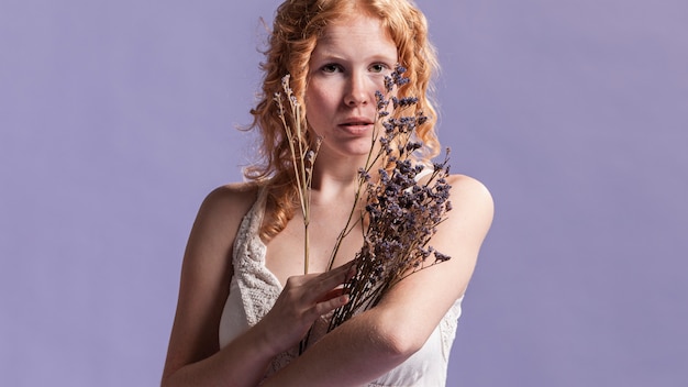 Free photo redhead woman posing with lavender