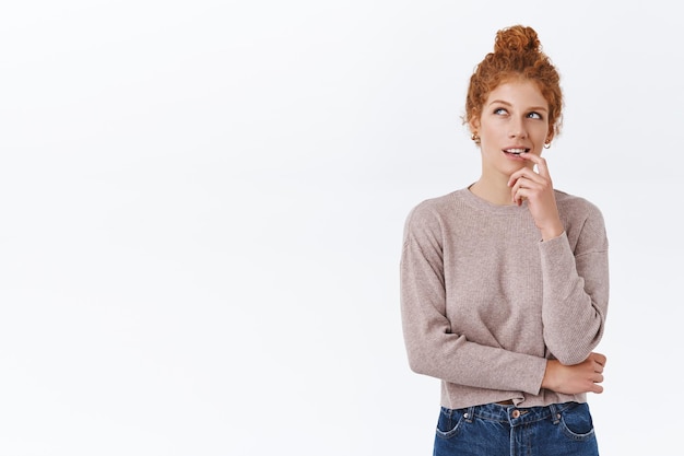 Free photo redhead woman with curly hair combed in bun