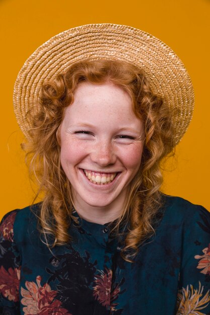 Redhead young woman laughing and looking at camera