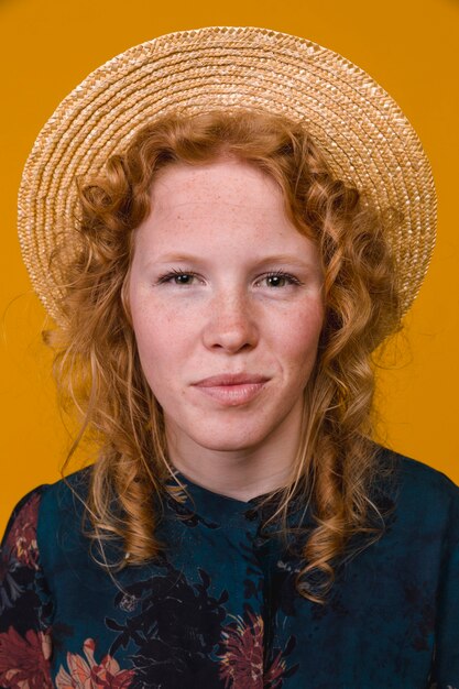 Redhead young woman smiling and looking at camera