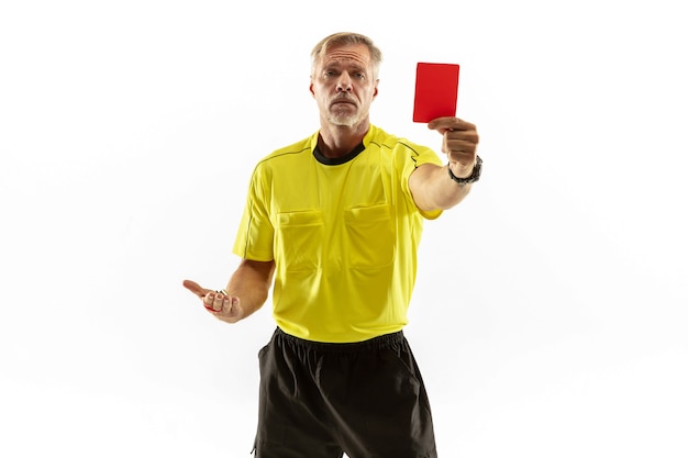 Referee showing a red card to a displeased football or soccer player while gaming isolated on white studio background.