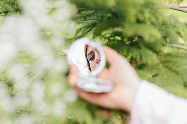 Reflection of woman in hand mirror 