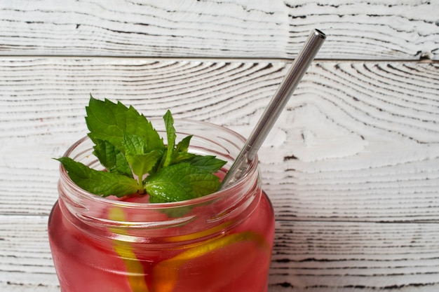 Free photo refreshing hibiscus ice tea in clear glass container