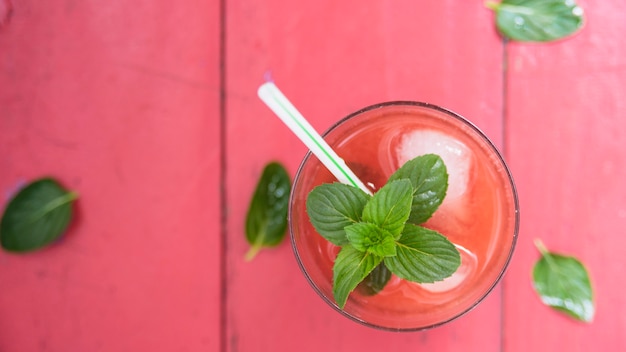 Free photo refreshing red drink with herbs