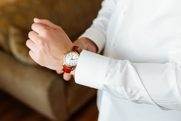 Free photo rehearsal preparation. groom's watch on hand.