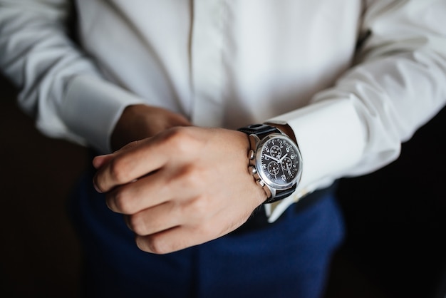 Rehearsal preparation. Groom's watch on hand. 