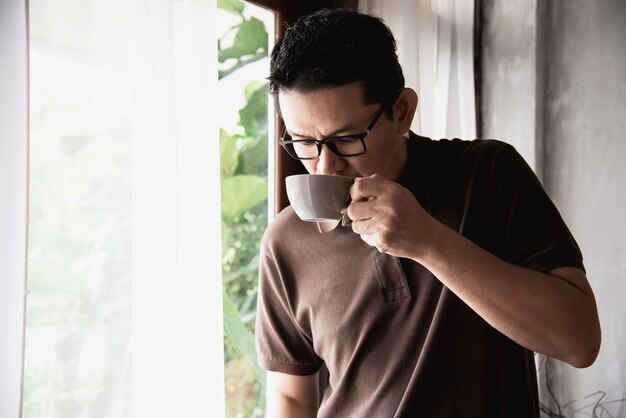 Relax Asian man drinking a coffee 