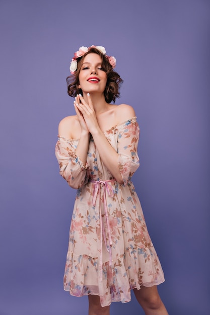 Free Photo relaxed female model in spring dress posing. spectacular caucasian lady with roses in hair looking.