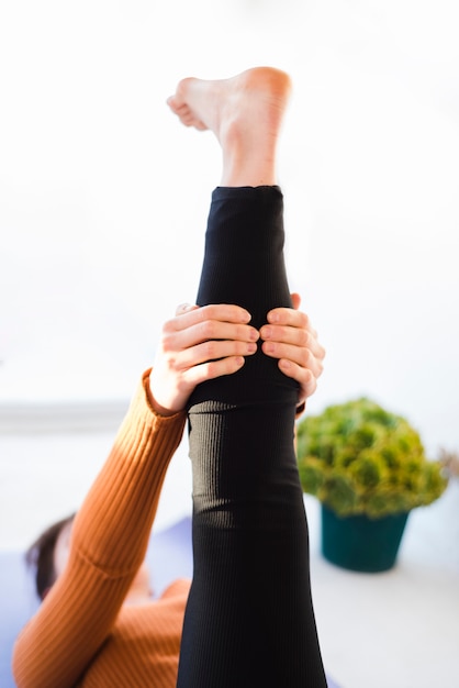 Relaxed girl practicing yoga at home