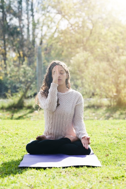 Relaxed girl practicing yoga outdoor