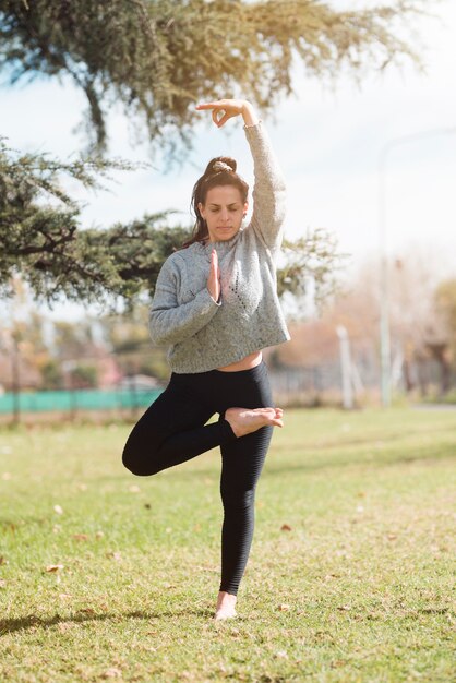 Relaxed girl practicing yoga outdoor