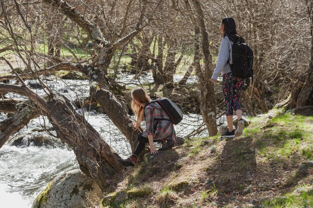 Relaxed girls next to a river