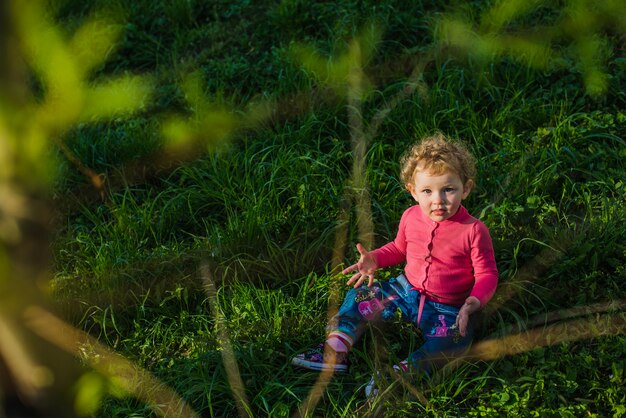 Relaxed kid on the lawn