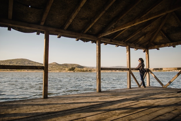 Free Photo relaxed woman looking at the lake