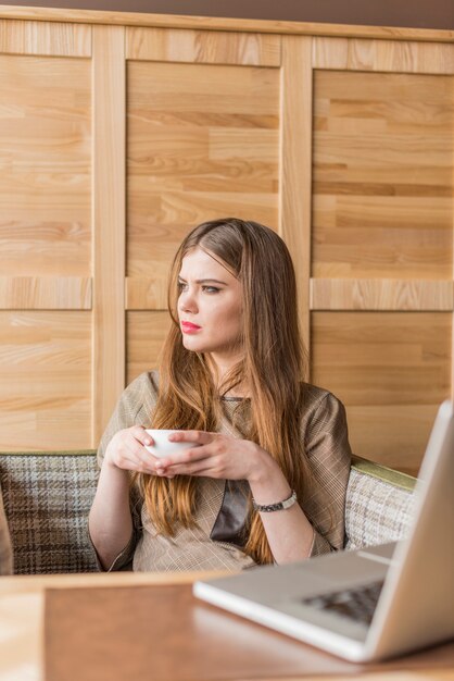 Relaxed woman with a cup in hands