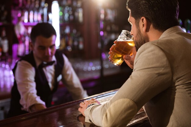 Relaxed young man drinking glass of beer