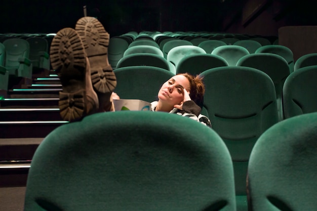 Free photo relaxing woman waiting for cinema session