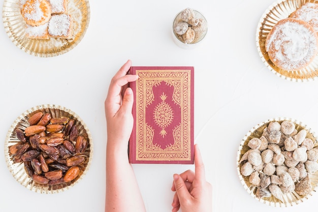 Religious book surrounded between sweets