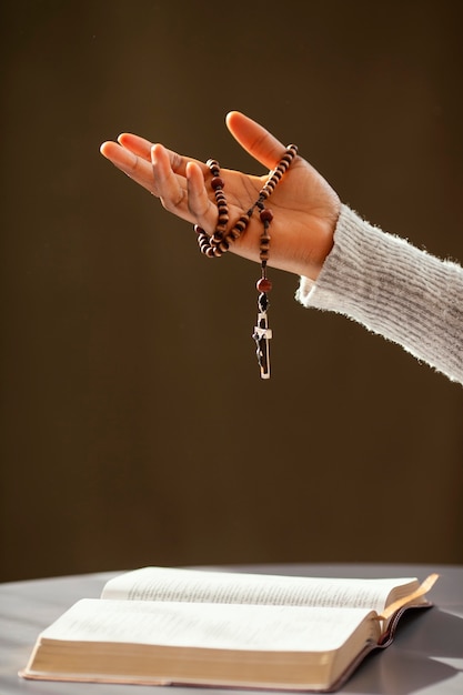 Free photo religious woman praying with rosary beads