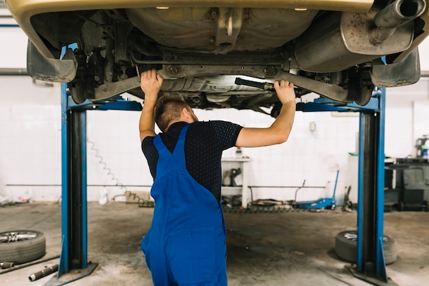 Free Photo repairmen examining car bottom