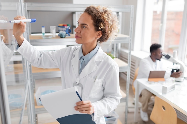 Researcher with clipboard in the biotechnology laboratory