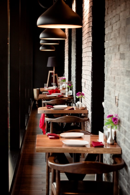 A restaurant corridor with small two people tables