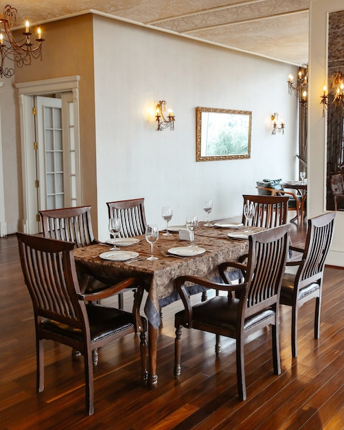 Free Photo restaurant table with wooden chairs placed in hall decorated in classical style