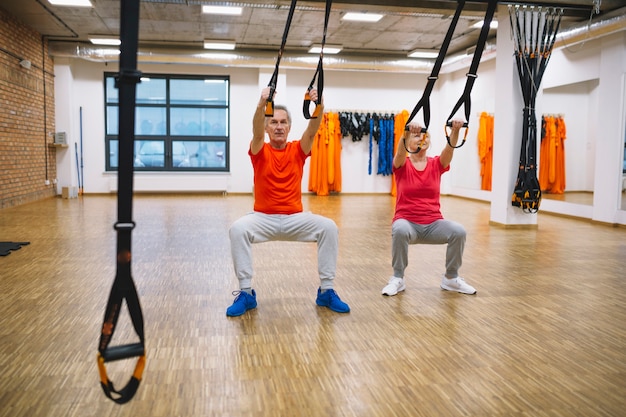 Retired couple training with ropes