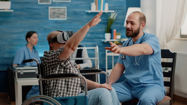 Free photo retired woman using vr glasses and nurse assisting