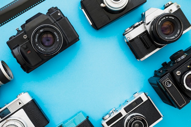 Free photo retro cameras near piece of film