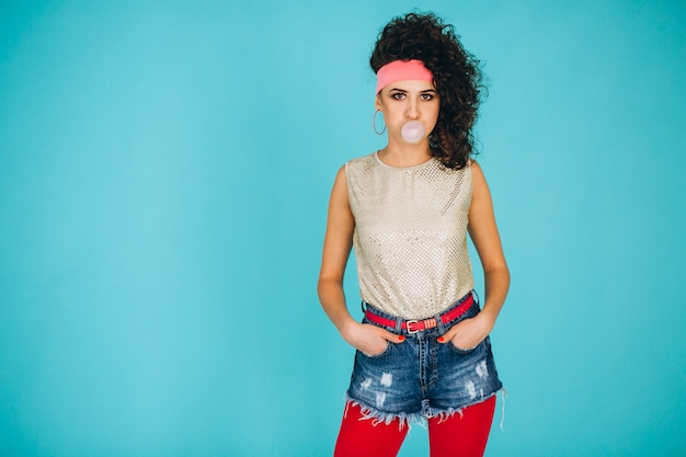 Retro girl blowing bubble with chewing gum