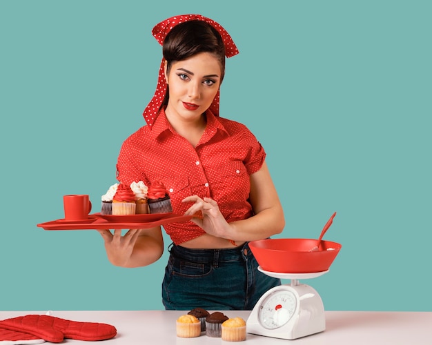 Free photo retro pinup girl posing in a kitchen