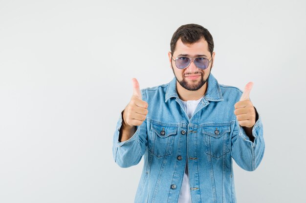 Retro-style man in jacket,sunglasses showing thumb up and looking impressive , front view.