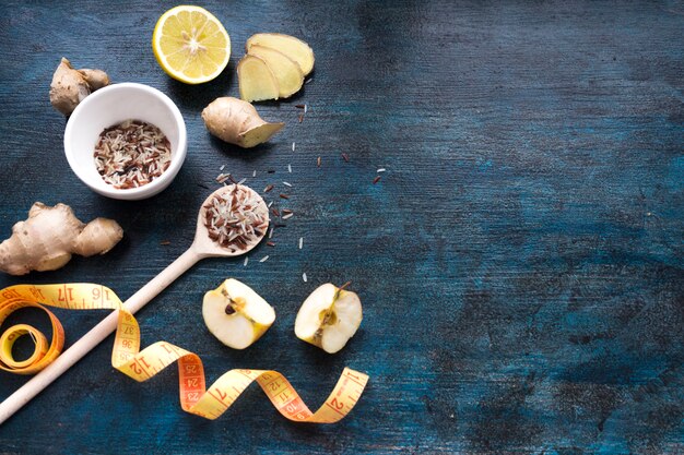 Rice in bowl with apples and measuring tape 