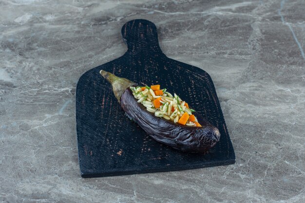 Rice in eggplant on the cutting board, on the marble table. 