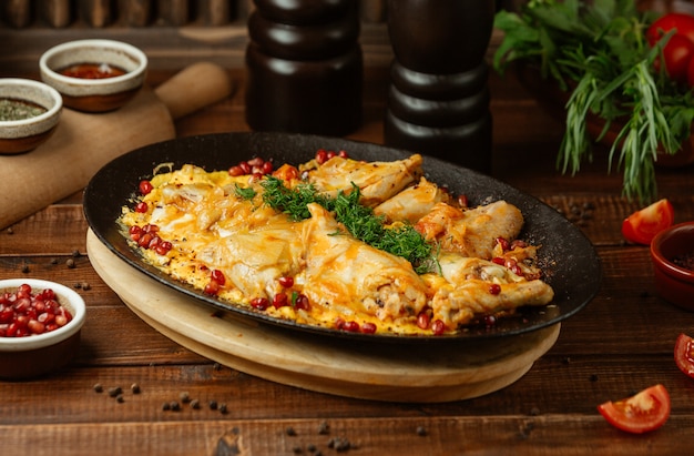 Free Photo rice garnish with herbs and chicken breast in iron plate