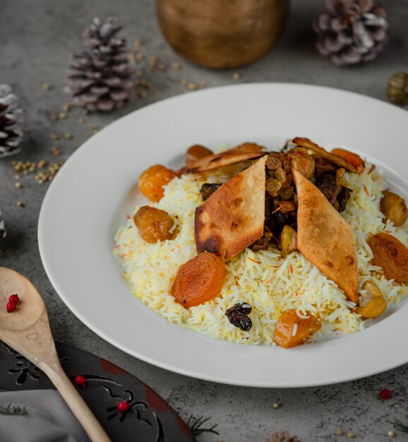 Free Photo rice garnish with nuts and dry fruits inside white plate.