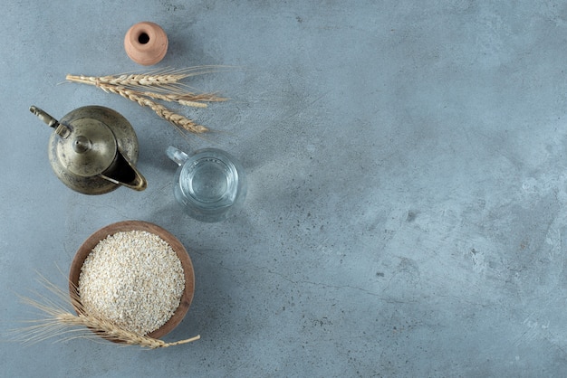 Rice plant with metallic kettle around on a blue background. High quality photo