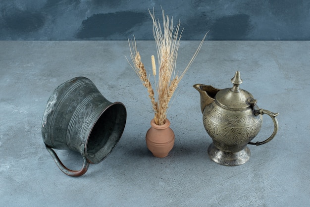 Free Photo rice plant with metallic kettle around on a blue background. high quality photo