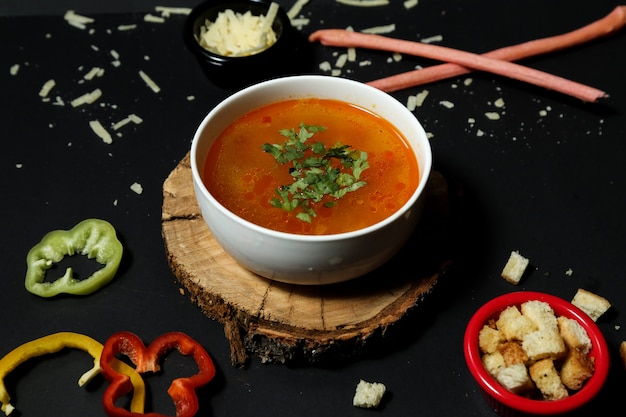 Rice soup in bowl crackers onion bell pepper side view