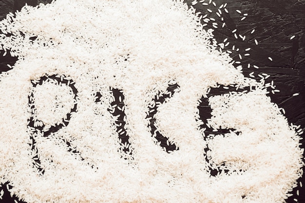 Free Photo rice text written in uncooked rice grain on textured background