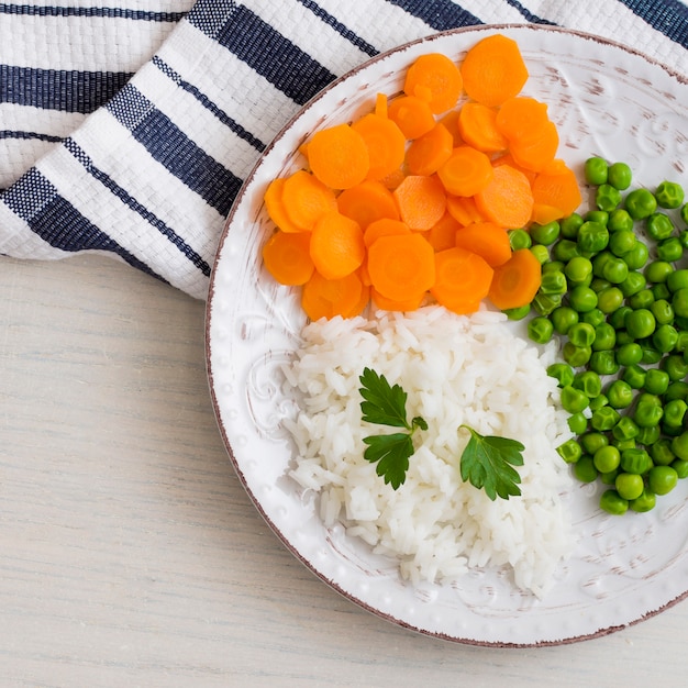 Free Photo rice with vegetables and parsley on white plate