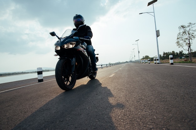 Rider Motorbike on the road riding. having fun driving the empty road