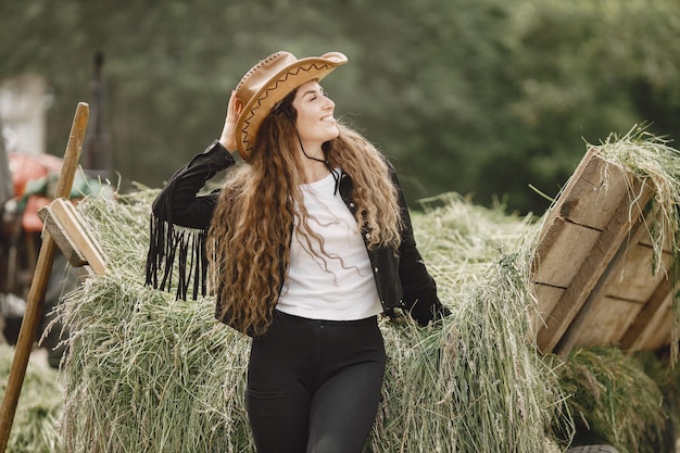 Rider woman does not look at the camera. Woman has long hair and black clothes