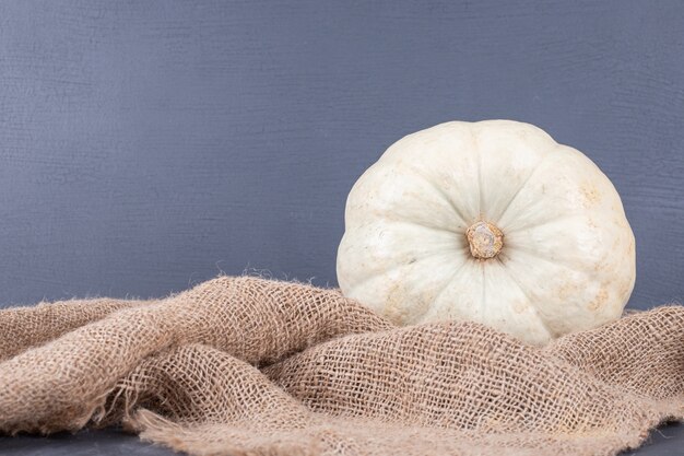 Ripe big pumpkin on burlap.