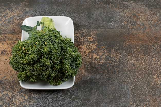 Ripe broccoli in the bowl on the marble surface