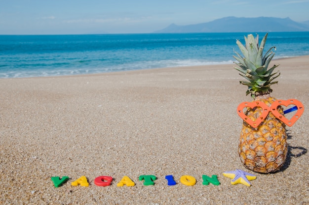 Ripe fruit in glasses on sand