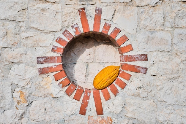 Ripe juicy turkish melon in a round niche on a white stone wall photo with copy space organic fruit market advertising idea Concept for background or article