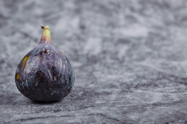 Free photo ripe purple fig on a marble table.