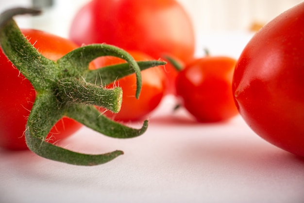 Ripe red tomatoes on white background